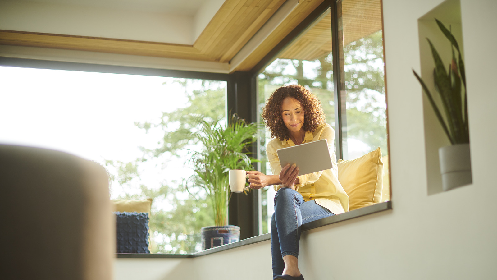 Bright window seat with a closed laptop suggesting a short break